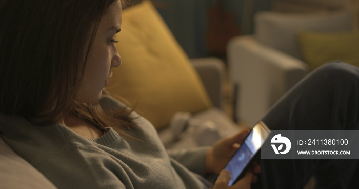 Teenager sitting on the couch and chatting