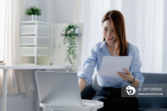 Business woman in the living room, she working from home due to the COVID-19 situation, she presenting to managers, online meeting via remote conferencing program. Work from home concept.