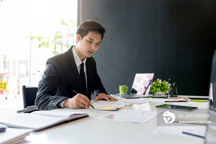 Businessman sitting analyze document information in the workplace.