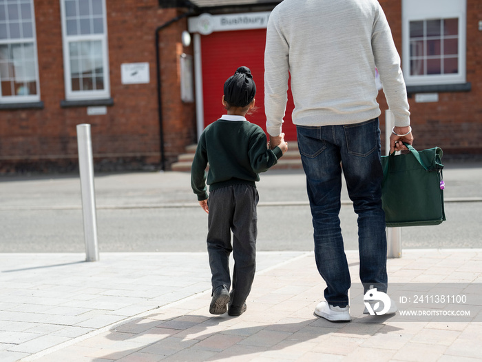 Father walking son (6-7) to school