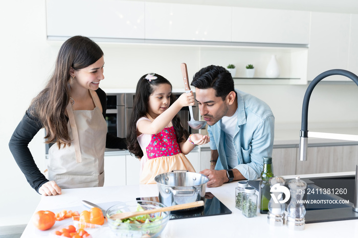 Family Cooking Food Together At Home