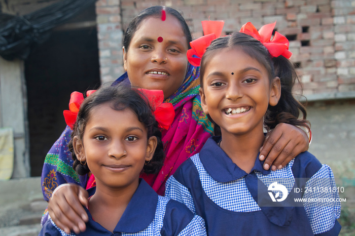 Indian rural family posing in front of camera in outdoor