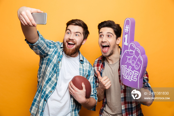 Portrait of a two excited young men taking a selfie