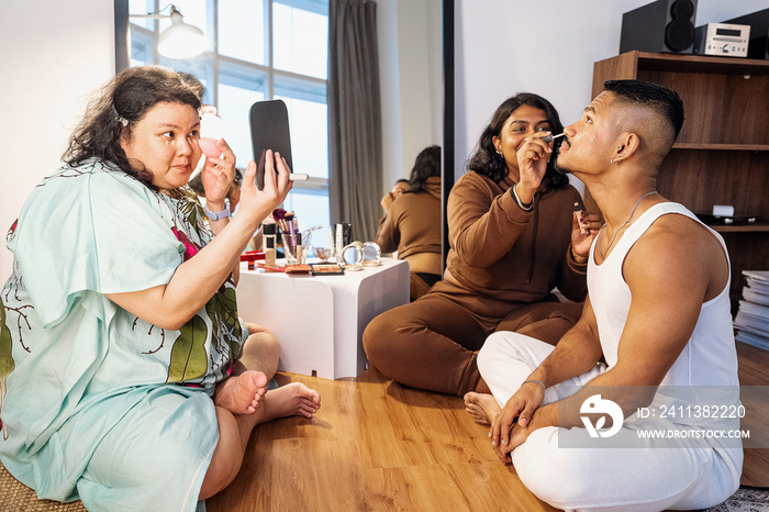 Group of friends doing each others make up at home during a sleepover