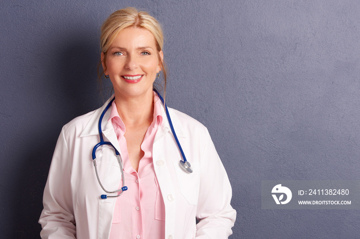 Smiling elderly female doctor portrait. Studio shot.