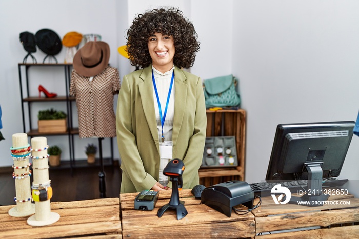 Young middle eastern woman working as manager at retail boutique with a happy and cool smile on face. lucky person.