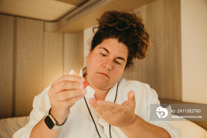 plus size woman putting lotion on hands