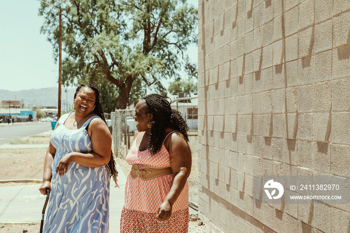 2 plus size African American women laugh