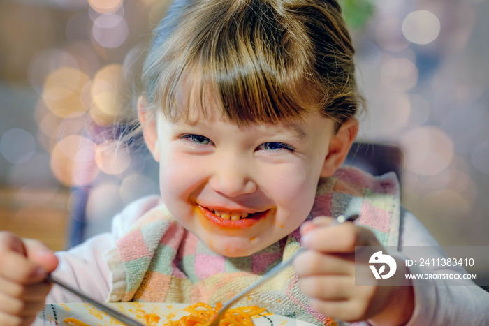 cute little girl eating spaghetti bolognese