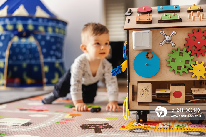 Adorable toddler playing interactive games for good development at home.