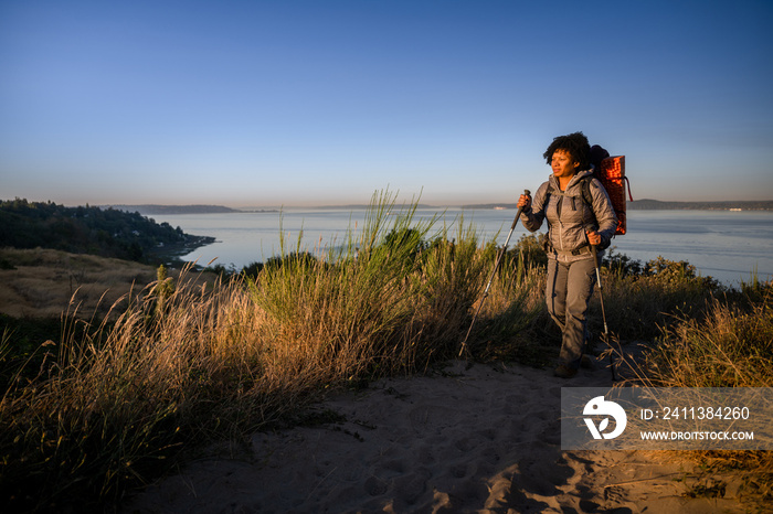 U.S. Army female soldier putting in the miles with an early morning hike in the NorthWest.