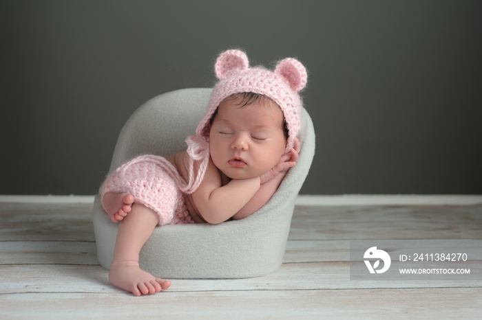 Newborn Girl Wearing a Pink Bear Hat