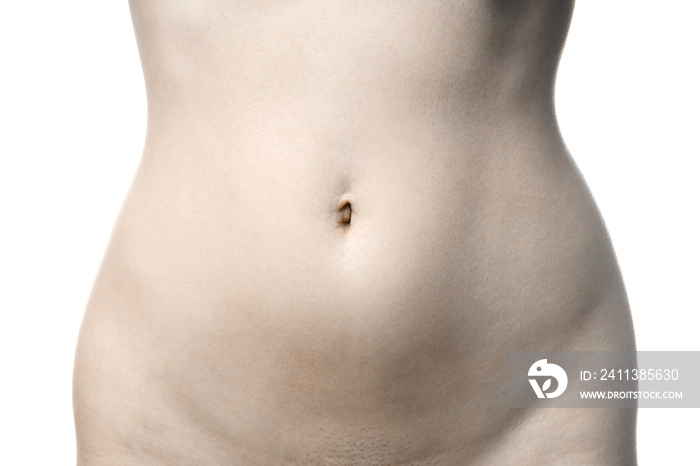 midsection of unrecognizable naked woman - female stomach body part with belly button and shaved pubes - women’s health concept