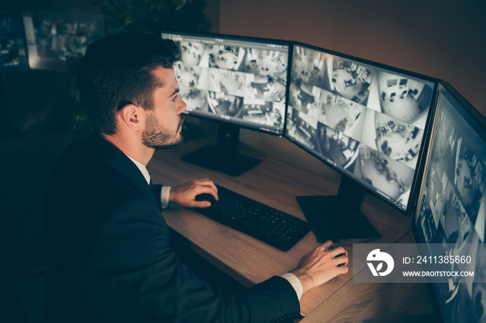 Profile side view portrait of his he nice attractive serious focused skilled man providing remote service supervising tv cam using panel at workplace workstation indoors