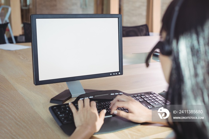 Cropped image of businesswoman working on computer at call