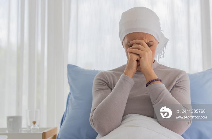 A middle-aged breast cancer woman feels hopeless and fear for her sickness and praying for calmness and mind serenity