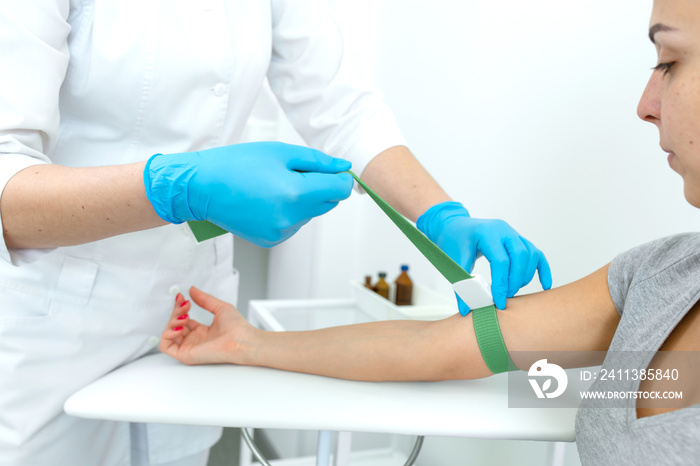 the nurse fastens the clip on the patients hand before the blood sampling procedure.