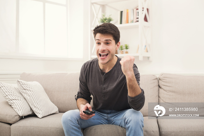 Man watching sports on tv and supporting team