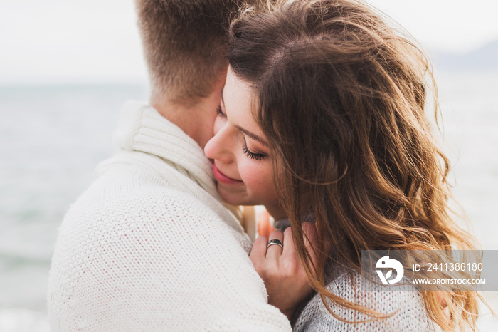 Close-up portrait of man and woman together, happy, looking at each other. Smiling, kissing and laughing