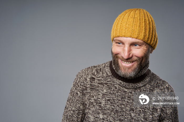 Happy laughing mature man in warm sweater