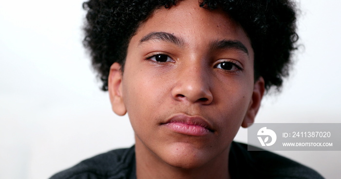 Mixed race young boy smiling at camera portrait. Ethnically diverse male kid