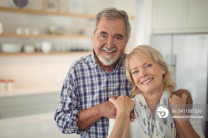 Senior couple hugging each other at home