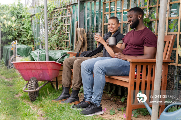 Smiling couple relaxing in urban garden