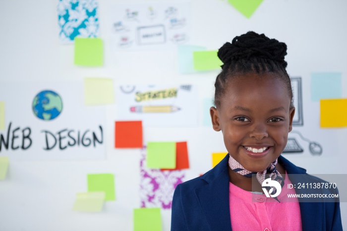 Smiling little girl pretending to be businesswoman