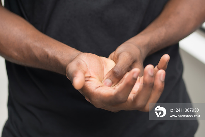 african man suffering from wrist or hand pain; sick black man with cps wrist pain, trigger finger, bone arthritis, gout symptoms; sickness, health care or pain concept; adult african man model