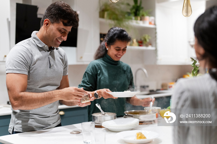 Family at table preparing meal together