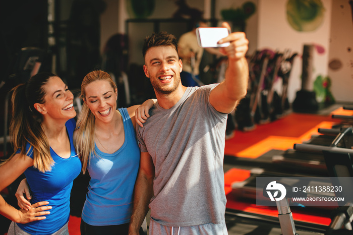 Friends making selfie in the gym