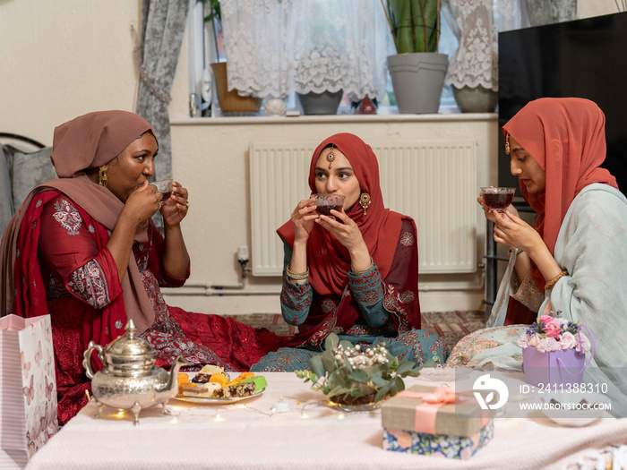 Women having tea during Ramadan celebration at home