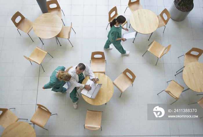 Top view of three physicians during work break in the cafeteria