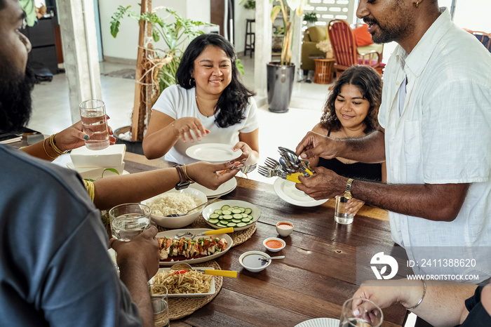 Group of friends sharing a meal together at home