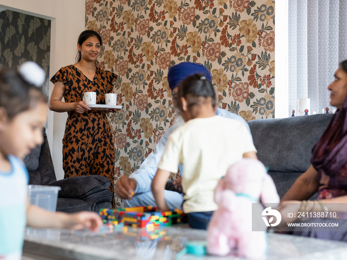 Three-generation family (6-7) relaxing at home