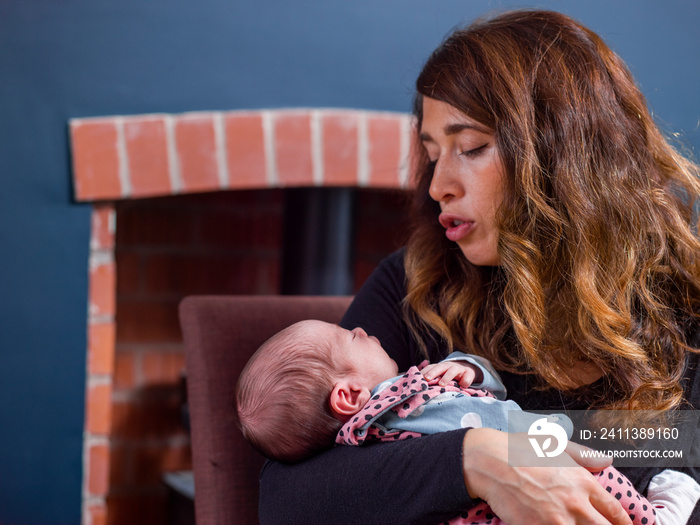 Woman holding baby son   at home