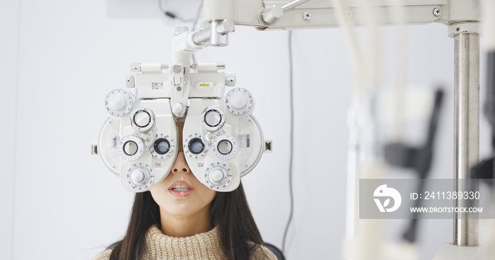 Asian Woman doing eye test in clinic