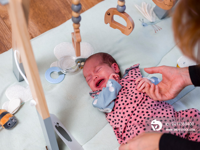 Close-up of woman consoling crying baby son