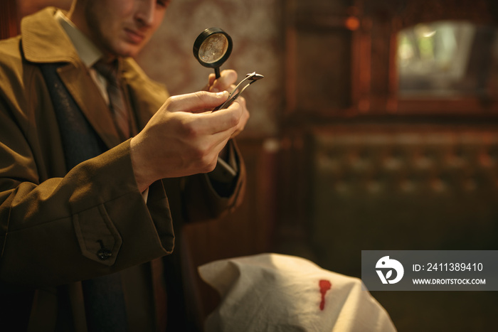 Detective looks evidence through magnifying glass