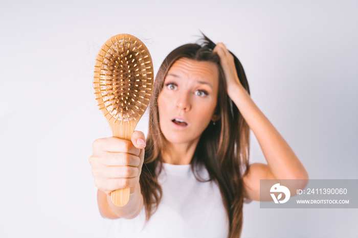 Shocked woman with hair loss problem. Hair falling out