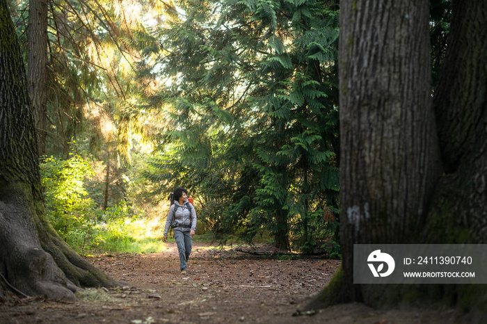 U.S. Army female soldier putting in the miles with an early morning hike in the NorthWest.