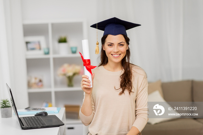 education, graduation and people concept - happy female student with diploma at home