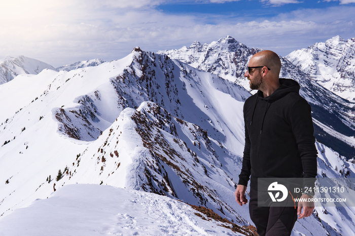 Handsome Male Model On Mountain Summit In Snow