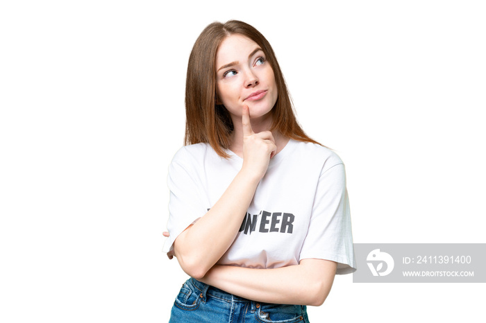 Young volunteer woman over isolated chroma key background having doubts while looking up