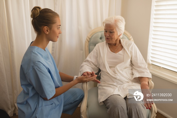 Female physician consoling senior woman