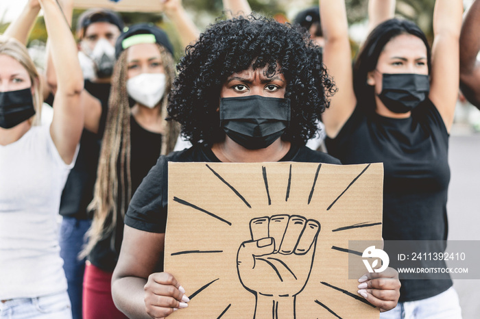 People from different culture and races protest on the street for equal rights - Demonstrators wearing face masks during black lives matter fight campaign - Focus on black girl