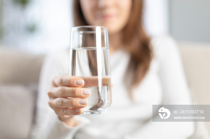 Woman drinking water at home