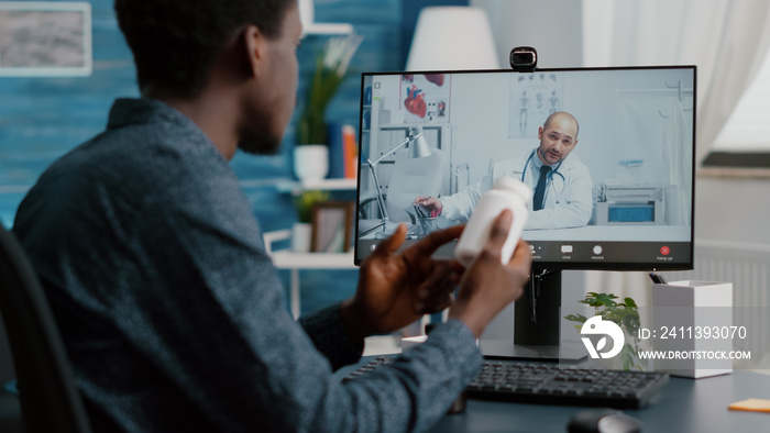 Black man at home seeking medical help from doctor via online intenet telehealth consultation with family doctor. Health care checkup via video virtual conference, patient looking for medicine advice