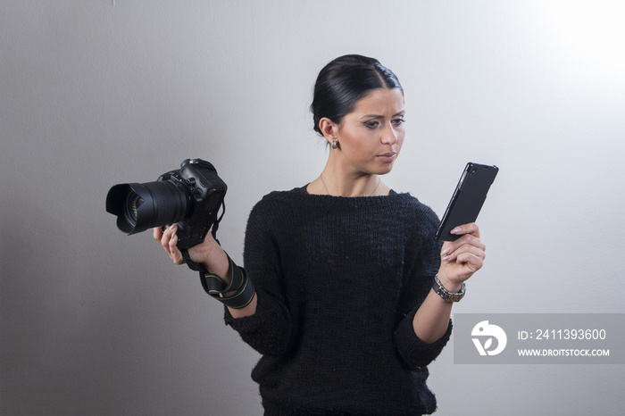 Young woman confused with her camera settings, trying to figure out how to use her professional DSLR camera