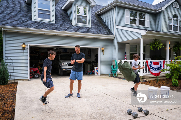 Air Force service member trains with his sons in a morning workout in preperation for a PT fitness test.